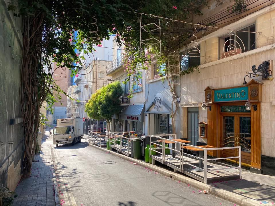 Sunlit street with Valentino storefront