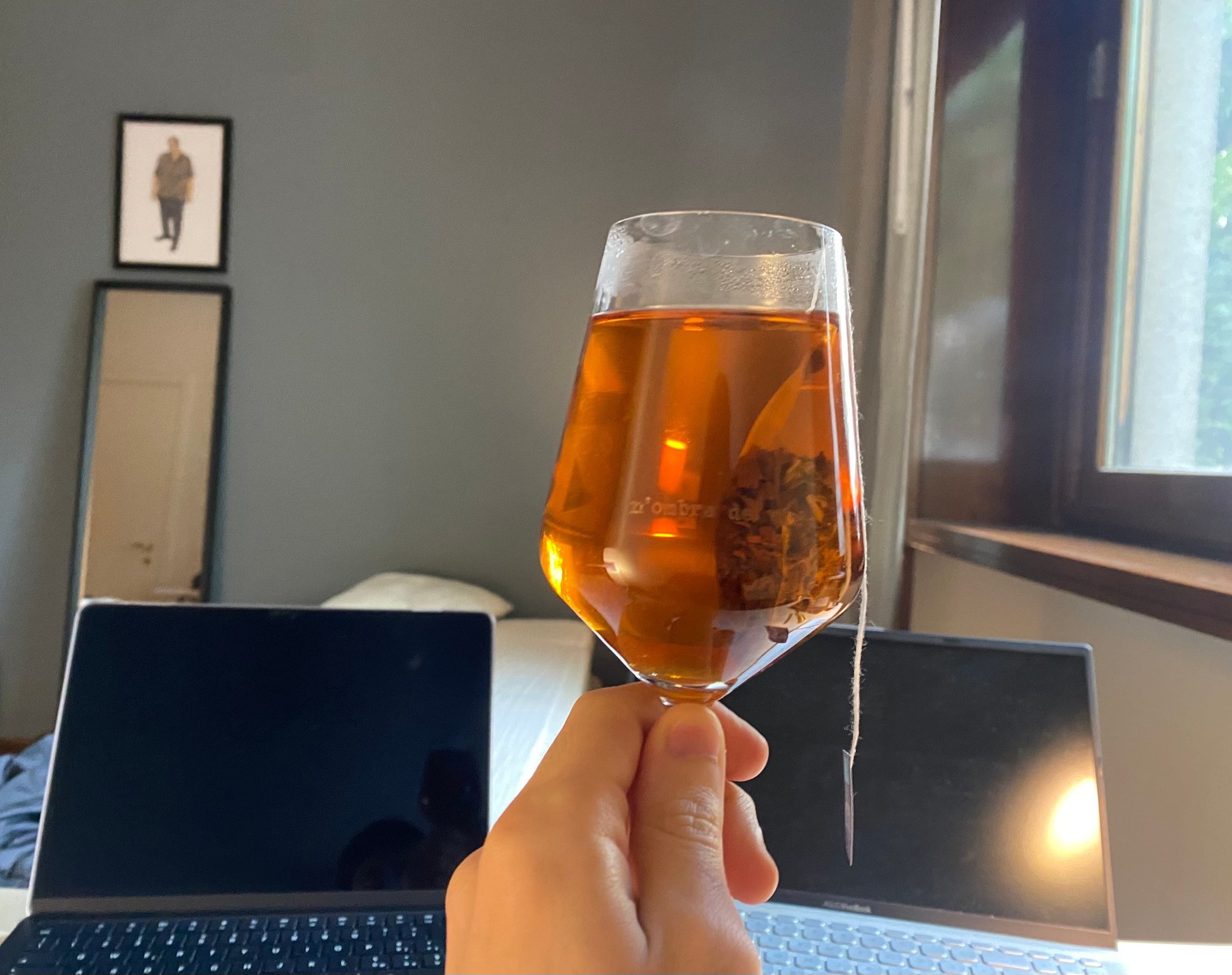Tea glass in front of laptop workspace